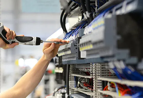 Electrician wiring a control panel